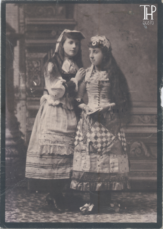 pair of young girls in homemade dresses