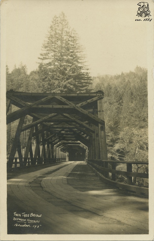view of wooden "Twin Tree" bridge on Redwood Highway